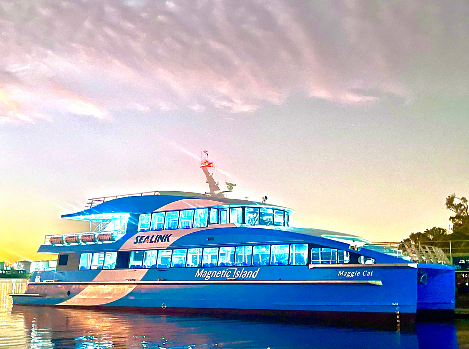 SeaLink vessel "Maggie Cat" at sunset with lights on