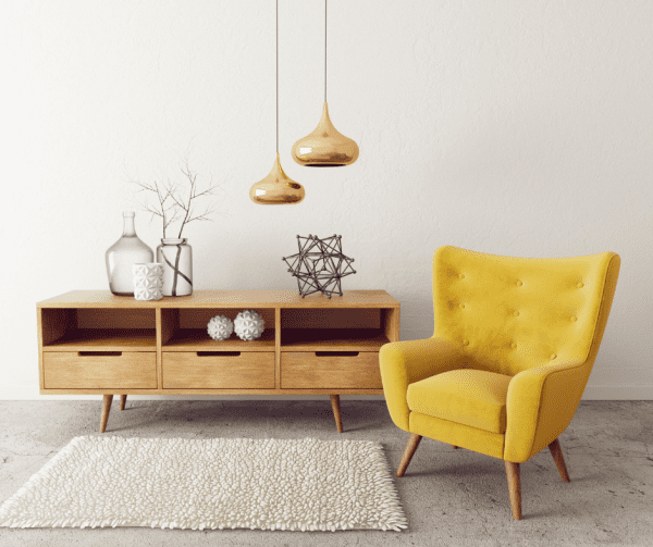 yellow chair beside sideboard with vases and decorations, pendant light.