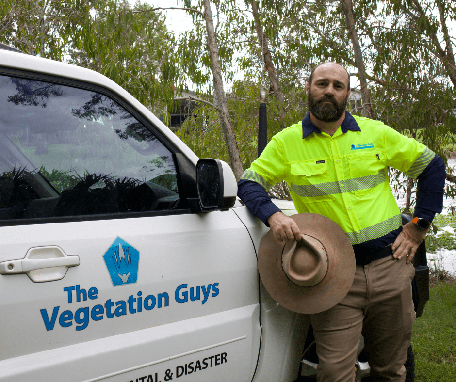 Man standing near white vehicle with 'The Vegetation Guys' written in blue on door. BDmag April 2023