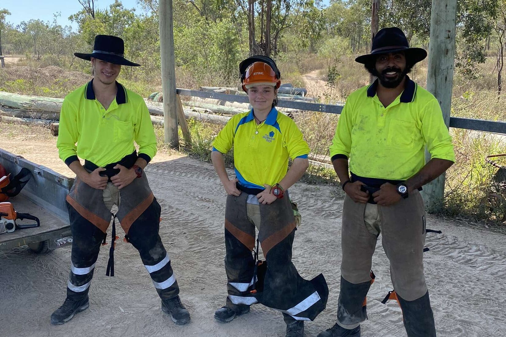 Three people in high vis clothing part of The Vegetation Guys work crew.