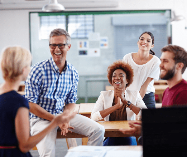 Group of people at work smiling and laughing. Good HR Practice: It's about culture, not compliance - Active HR | BDmag July 2023
