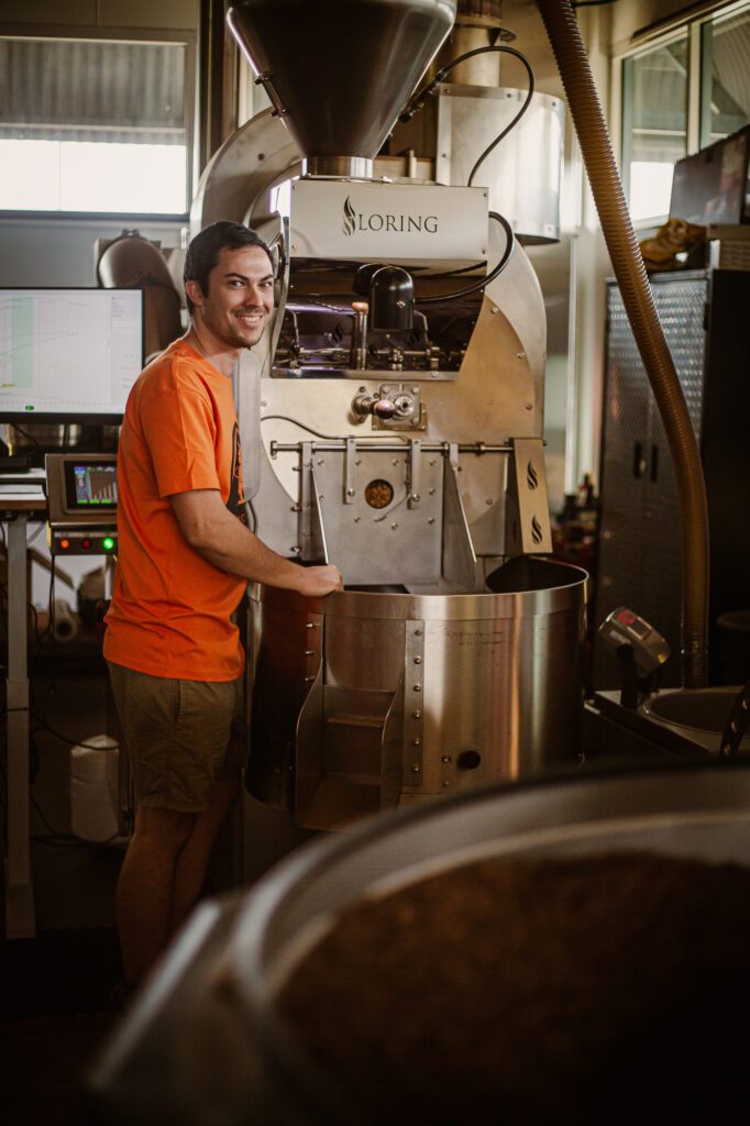 Coffee Dominion staff member Joe Thomas, with the Loring S35 Kestral air roaster. Pioneering Townsville's Coffee Culture | BDmag October 2023