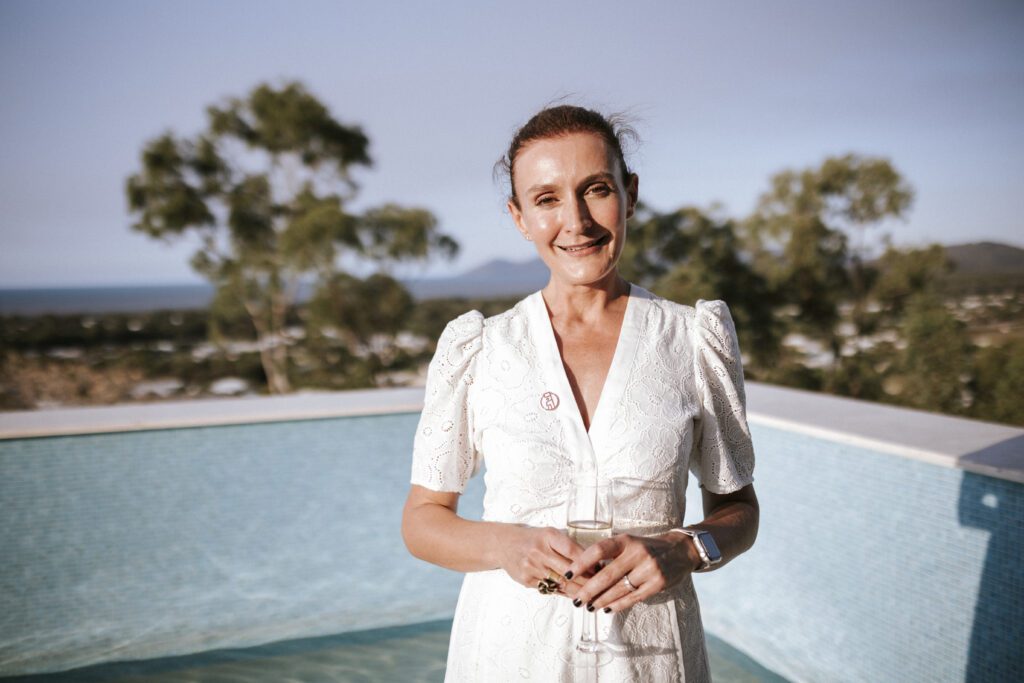 Louise Ashford with Airbnb badge near pool Britomart. BDmag 5 Minutes With Louise Ashford - Sublime Experiences | October 2023