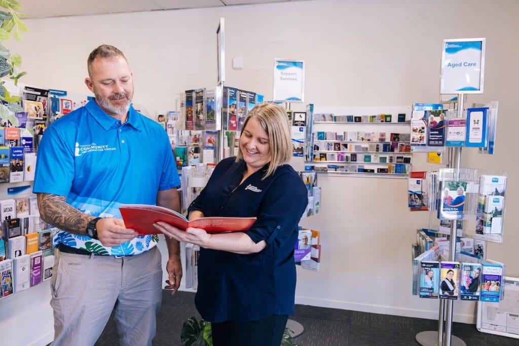 Townsville community information centre employee working with client. January 2023 BDmag